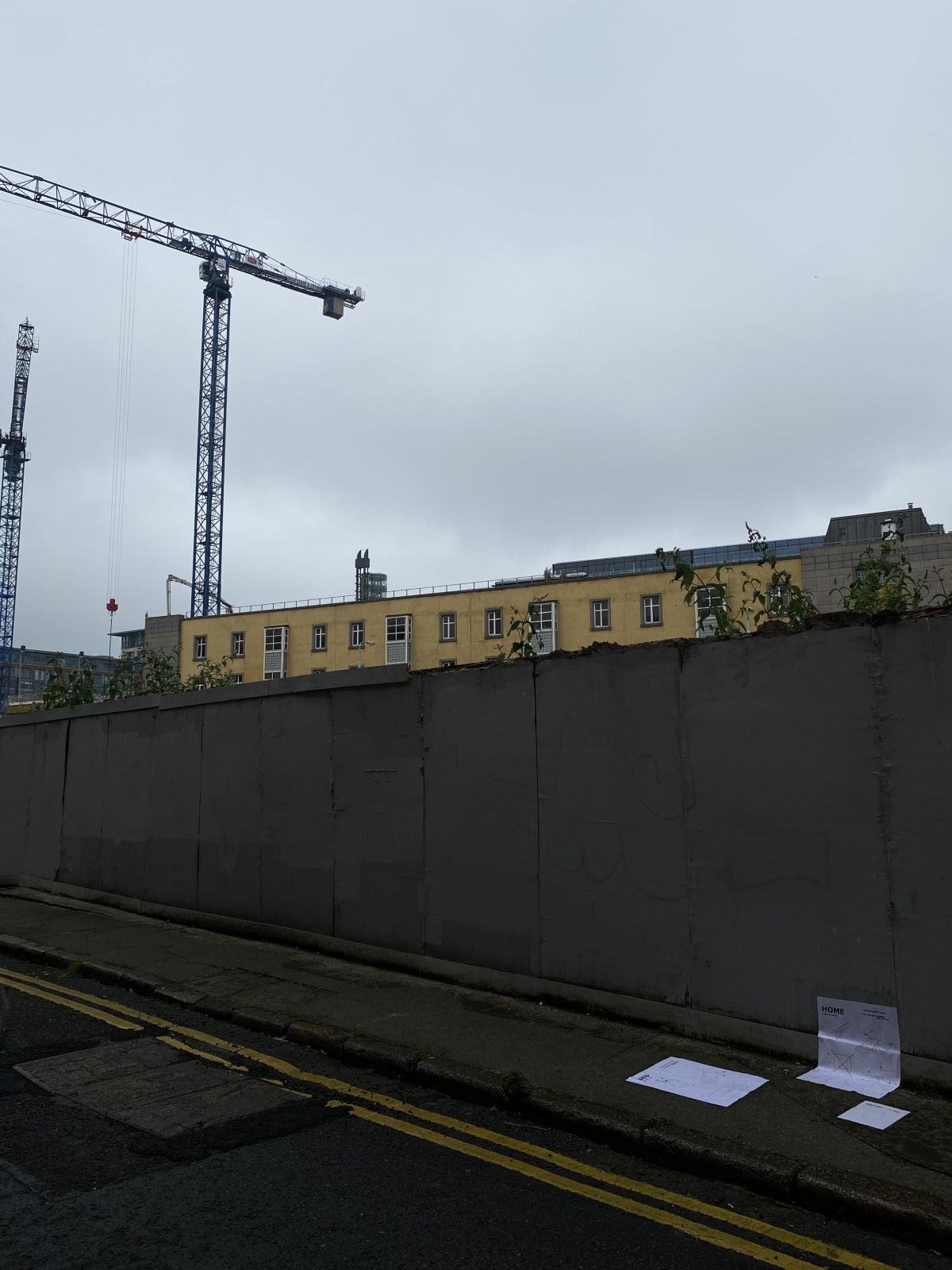 4. Crane. The scale of the buildings in the background contrasting with the posters merely placed against the wall, reflecting the life of a homeless person.