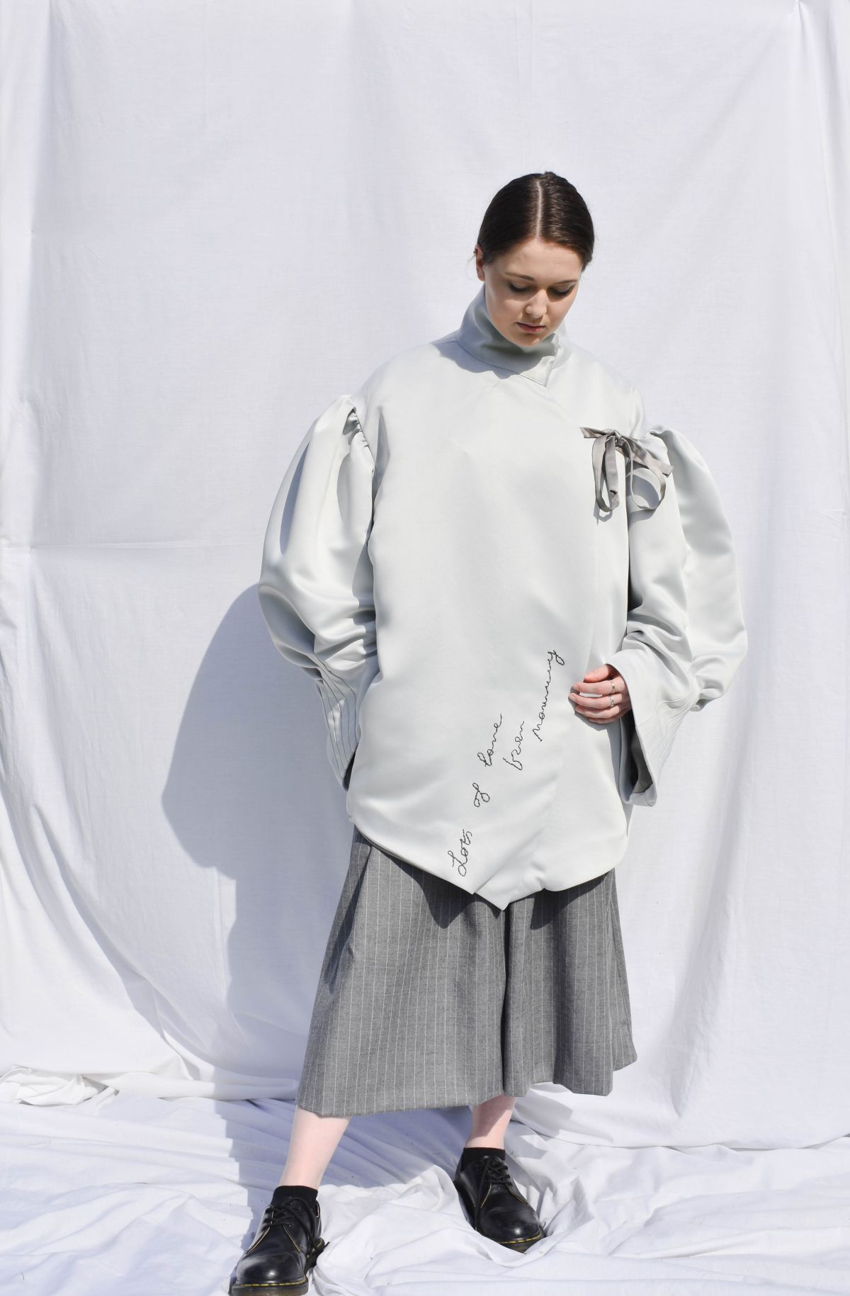-Every Grace and Blessing You Need - Outfit 1; Outer layer, Heavy bonded satin with hand embroidery details, suiting wool trousers with large outer pocket detail.